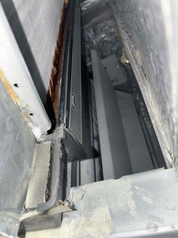 Completed air conditioning tune-up service as scheduled. Performed standard maintenance protocol including system inspection, filter check, and operational testing of cooling components. Documented existing exterior window frame corrosion and deterioration at service location for customer awareness, noting rust-colored oxidation along frame joints and track assembly showing moisture exposure and debris accumulation unrelated to HVAC equipment.