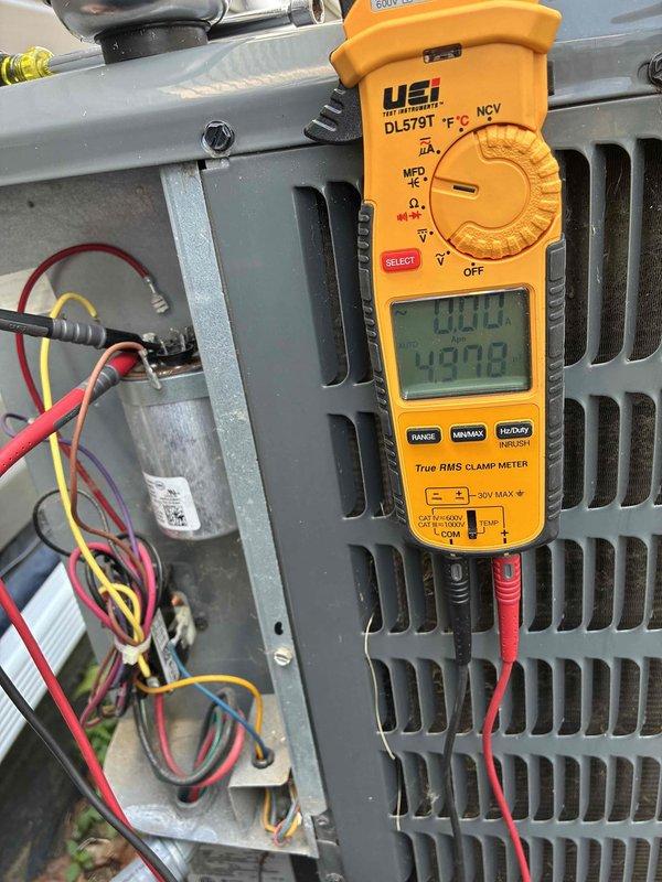 Performed comprehensive cooling system maintenance on HVAC unit. Conducted electrical diagnostics using digital clamp meter, verifying voltage readings at 930.0V and amperage draw at 49.78A on primary circuit, with secondary measurements showing 5.67A draw. Inspected all electrical components within control panel including capacitor, wire connections, and terminal blocks, confirming proper operation and secure connections throughout the system.