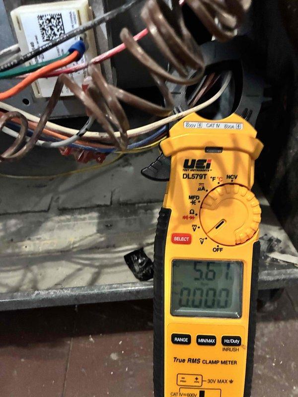 Performed comprehensive cooling system maintenance on HVAC unit. Conducted electrical diagnostics using digital clamp meter, verifying voltage readings at 930.0V and amperage draw at 49.78A on primary circuit, with secondary measurements showing 5.67A draw. Inspected all electrical components within control panel including capacitor, wire connections, and terminal blocks, confirming proper operation and secure connections throughout the system.