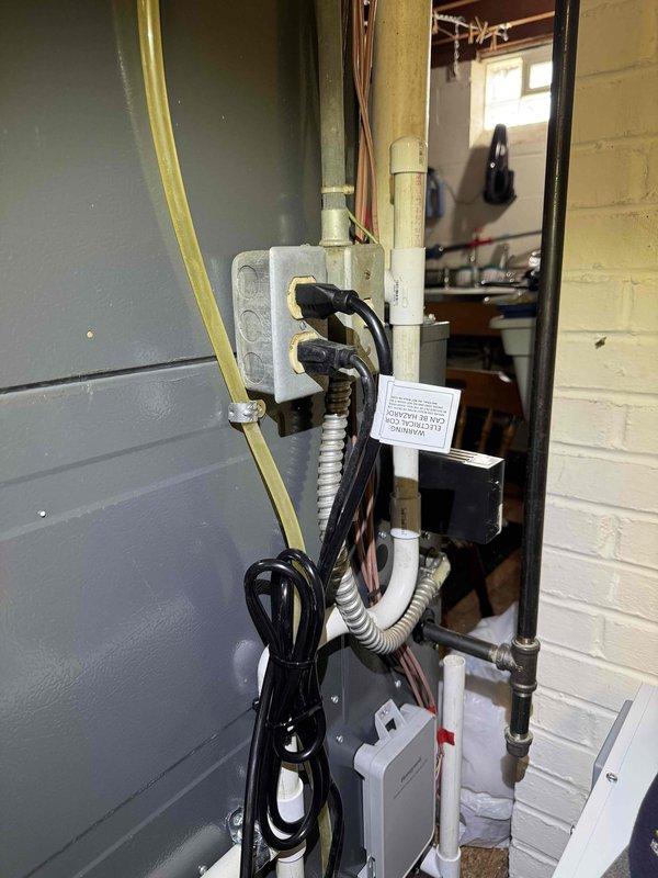 Installed whole home dehumidifier system in mechanical room, including mounting unit on concrete block platform, establishing electrical connections via dedicated circuit, and integrating supply and return ductwork with existing HVAC infrastructure. Completed all necessary condensate drain line connections using PVC piping to ensure proper moisture removal and system operation.