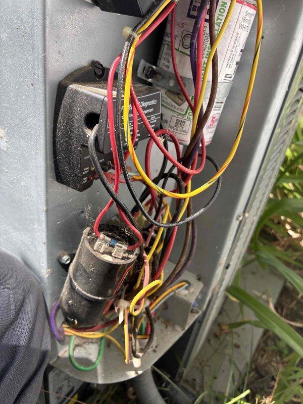 Completed routine cooling system maintenance on outdoor condensing unit. Inspected electrical components including contactor, capacitor, and control board; verified all wire connections were secure and properly terminated. Cleaned exterior louvers and grille to ensure adequate airflow through the unit. All components found in good operating condition with normal wear consistent with outdoor installation.