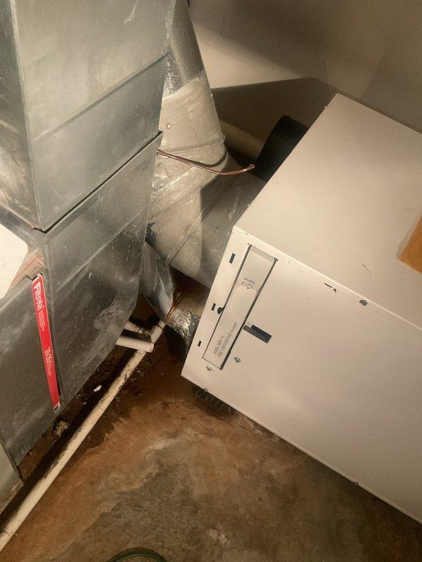 Completed estimate for replacement of non-functional whole-home dehumidifier system. Evaluated existing IAQ equipment and ductwork installation in mechanical room, noting moisture damage and staining on supply duct indicating previous humidity issues. Recommended Aprilaire E100 or equivalent dehumidifier system to address indoor air quality concerns, as current unit is beyond repair.