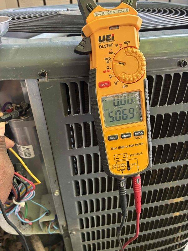 # HVAC Cooling Maintenance Completed

Performed comprehensive preventive maintenance on a 3-year-old residential cooling system following standard checkpoint protocol. Conducted electrical diagnostics using digital clamp meter, recording voltage readings of 586.9V to verify proper power supply to the outdoor condensing unit. Inspected and tested the run capacitor, confirming secure wire connections on all three terminals (compressor, fan, and common) with no signs of bulging, leaking, or degradation. All electrical components within manufacturer specifications and operating normally. System cooling efficiently with no deficiencies noted during inspection.