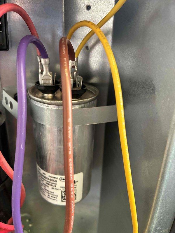# HVAC Cooling Maintenance Completed

Performed comprehensive preventive maintenance on a 3-year-old residential cooling system following standard checkpoint protocol. Conducted electrical diagnostics using digital clamp meter, recording voltage readings of 586.9V to verify proper power supply to the outdoor condensing unit. Inspected and tested the run capacitor, confirming secure wire connections on all three terminals (compressor, fan, and common) with no signs of bulging, leaking, or degradation. All electrical components within manufacturer specifications and operating normally. System cooling efficiently with no deficiencies noted during inspection.
