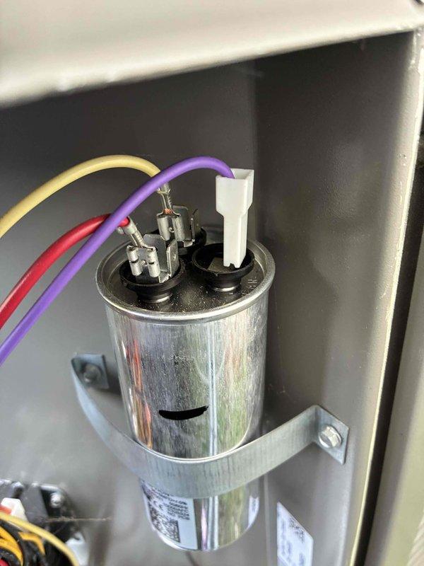 Completed routine cooling system maintenance as part of scheduled MVP recurring service. Performed comprehensive inspection of HVAC unit including examination of inducer motor assembly, electrical connections, and capacitor functionality. Verified proper wire connections with color-coded conductors (red, black, brown, blue, green, and ground), ensuring all connections were secure and properly routed. Inspected cylindrical run capacitor with yellow, purple, and red wire terminals, confirming proper mounting and operational condition with no signs of bulging, leaking, or deterioration. Checked blower assembly housing and motor components for proper operation and heat signatures. All electrical connections tested and found secure with appropriate cable management in place. System operating within normal parameters upon completion of maintenance visit.