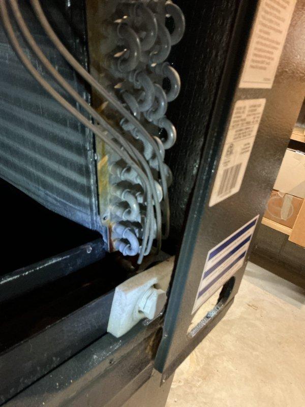 Replaced failed evaporator coil drain pan on air handler unit. Removed old corroded pan showing signs of rust and deterioration, installed new drain pan assembly, and verified proper drainage operation. System tested and confirmed operational with no leaks detected.