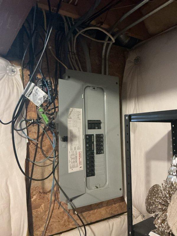 Conducted on-site assessment for electric vehicle charging station installation. Evaluated existing electrical panel capacity and available breaker spaces in basement utility area, documented current electrical infrastructure and wire routing pathways, and inspected garage location for optimal charger placement near interior access door. Photographed panel configuration and proposed installation area to develop comprehensive material and labor estimate for dedicated 240V EV charging circuit.