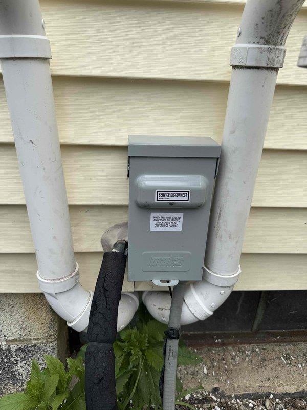 Returned to site to complete replacement of failed electrical disconnect and fuse for outdoor HVAC system. Installed new Hughes service disconnect box on exterior wall, ensuring proper mounting and weatherproofing. Replaced blown fuse and verified electrical connections to condenser unit. Tested system operation and confirmed proper voltage and amperage at disconnect. Unit cycling normally with all safety controls functioning as designed.