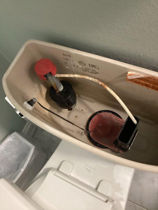 Responded to a two-toilet service call addressing separate mechanical failures. The first toilet exhibited continuous running caused by a malfunctioning fill valve float mechanism that failed to shut off water flow properly. The second toilet required repair of a broken flush handle assembly. Inspected both toilet tank interiors, identified worn components including deteriorated flapper valves and compromised fill valve assemblies with visible mineral deposit buildup affecting proper operation. Completed necessary repairs to restore full functionality to both fixtures.
