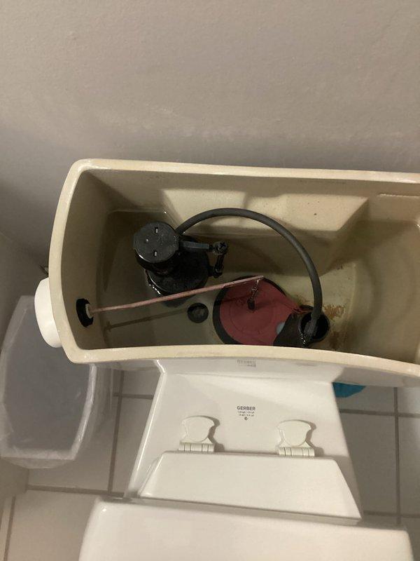 Responded to a two-toilet service call addressing separate mechanical failures. The first toilet exhibited continuous running caused by a malfunctioning fill valve float mechanism that failed to shut off water flow properly. The second toilet required repair of a broken flush handle assembly. Inspected both toilet tank interiors, identified worn components including deteriorated flapper valves and compromised fill valve assemblies with visible mineral deposit buildup affecting proper operation. Completed necessary repairs to restore full functionality to both fixtures.