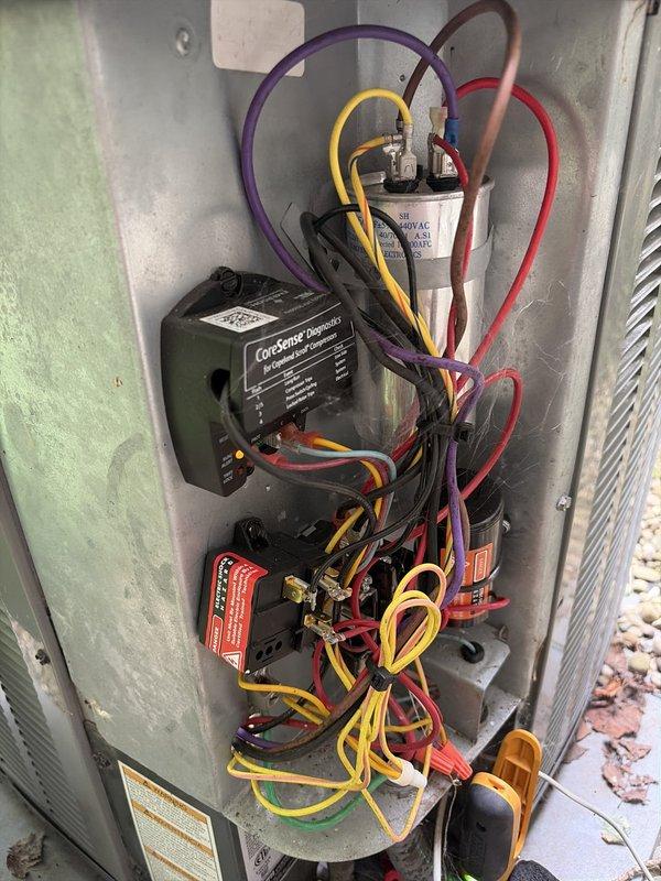Completed comprehensive cooling season tune-up on residential outdoor condensing unit. Performed full system inspection, verified electrical connections and capacitor operation, tested CoreSense Diagnostics module functionality, and confirmed proper refrigerant line connections. Unit operating within normal parameters with all components functioning correctly.