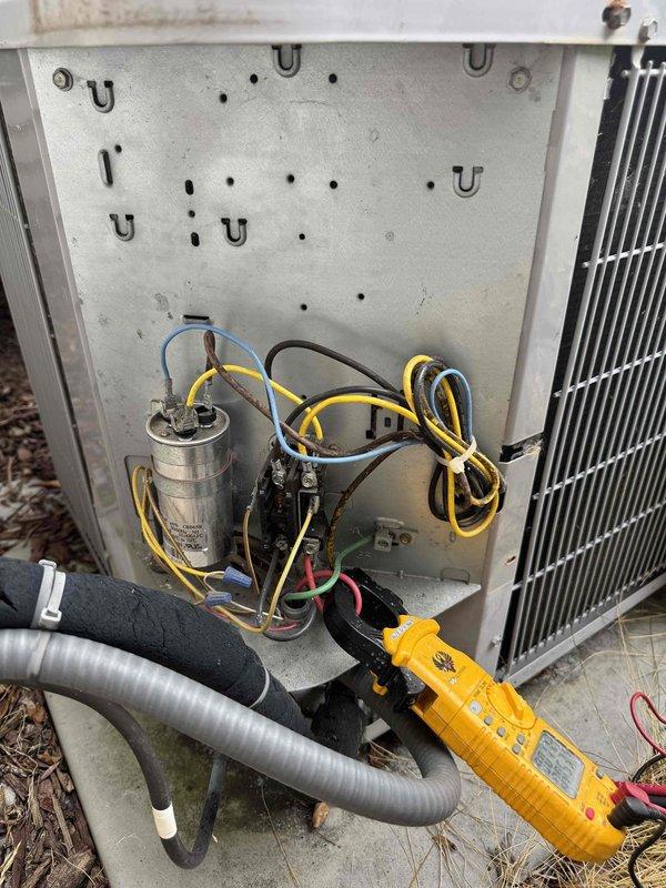 Performed comprehensive cooling season tune-up on residential HVAC system. Conducted electrical safety inspection including disconnect box examination and fuse assembly verification, tested capacitor functionality and voltage readings using digital multimeter, and confirmed all electrical connections were secure. System operating within normal parameters upon completion of preventative maintenance service.