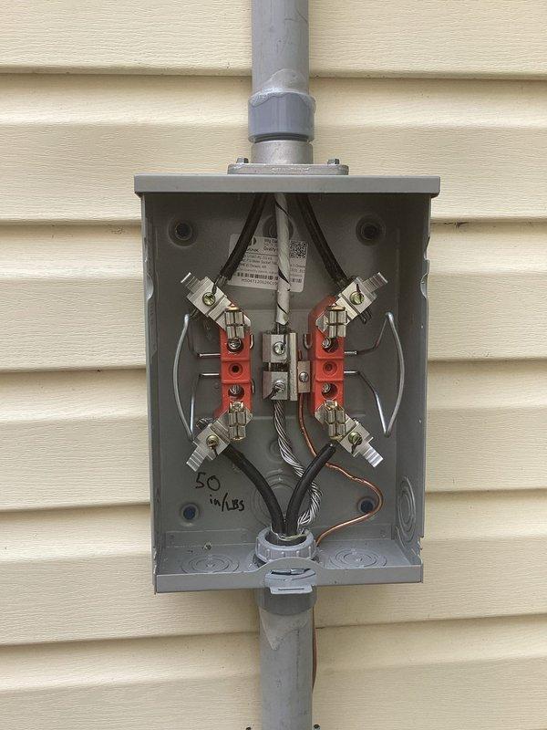 Replaced 100-amp exterior electrical service disconnect to bring installation into full compliance with current National Electrical Code requirements. Removed outdated disconnect equipment and installed new weatherproof metal enclosure with proper fuse holders, insulators, and terminal connections. Configured all electrical connections through code-compliant gray PVC conduit system with appropriate mounting brackets secured to building exterior, ensuring proper weatherproofing and protection of all electrical components.