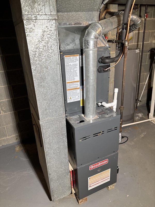 Completed installation of Goodman air conditioning system with new furnace unit in basement utility area. Installed and connected refrigerant lines, ductwork with insulated plenum, and integrated thermostat control. System tested and operational, with all components properly secured and code-compliant installation verified.