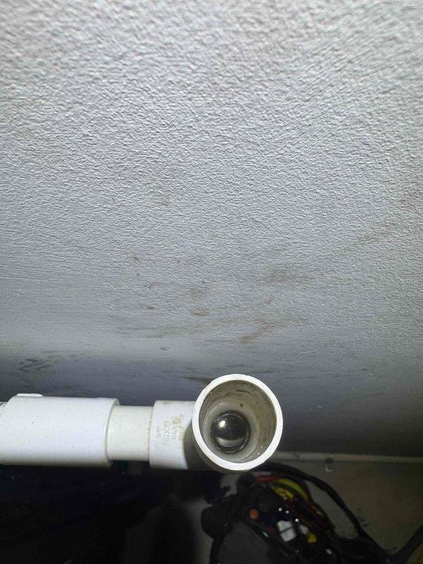 Responded to service call for air conditioning unit leaking water. Upon inspection, discovered severely corroded evaporator coil with significant rust and oxidation throughout the heat exchanger assembly. The coil showed advanced deterioration consistent with age and prolonged moisture exposure, which was the source of the water leak. Identified compromised condensate drainage system with PVC drain line showing signs of improper pitch or blockage contributing to water backup. Documented existing conditions with photographs showing extent of corrosion on copper tubing, fins, and internal components. Advised customer that the evaporator coil has reached end of serviceable life and requires replacement to resolve the leak issue permanently. Discussed options for repair versus system replacement given the advanced age and condition of the equipment.