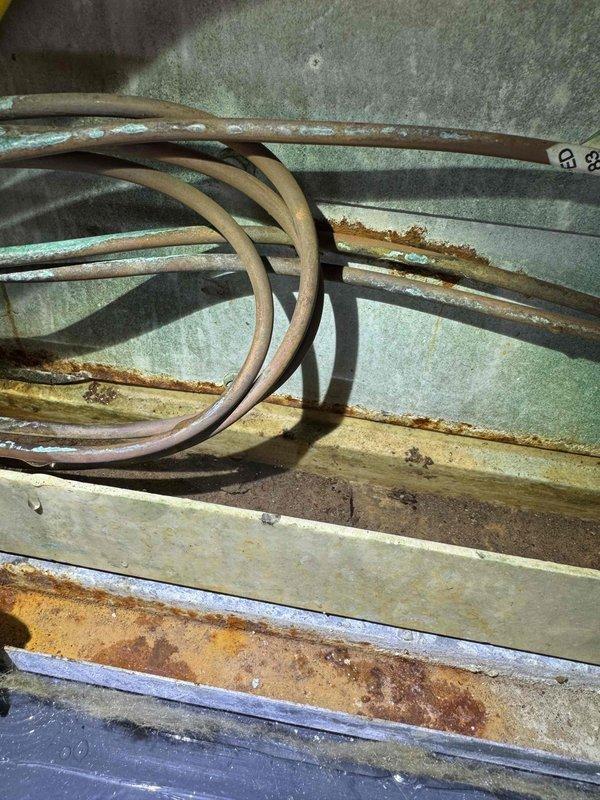 Responded to service call for air conditioning unit leaking water. Upon inspection, discovered severely corroded evaporator coil with significant rust and oxidation throughout the heat exchanger assembly. The coil showed advanced deterioration consistent with age and prolonged moisture exposure, which was the source of the water leak. Identified compromised condensate drainage system with PVC drain line showing signs of improper pitch or blockage contributing to water backup. Documented existing conditions with photographs showing extent of corrosion on copper tubing, fins, and internal components. Advised customer that the evaporator coil has reached end of serviceable life and requires replacement to resolve the leak issue permanently. Discussed options for repair versus system replacement given the advanced age and condition of the equipment.