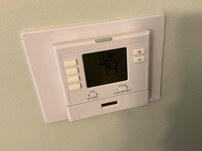 Conducted comprehensive assessment of existing 35-year-old HVAC system for complete replacement estimate. Evaluated current furnace and air conditioning equipment in basement utility area, documenting existing installation configuration including ductwork, condensate drainage system, gas connections, and thermostat controls. Photographed equipment specifications, existing PVC drainage piping, flexible ductwork connections, and programmable thermostat to determine appropriate replacement system sizing and compatibility requirements for full system upgrade proposal.