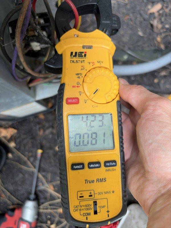 Performed routine preventive maintenance on residential Goodman air conditioning system. Conducted visual inspection of outdoor condenser unit, verified proper operation, and obtained electrical measurements using clamp meter showing compressor amperage of 4.23A and capacitance reading of 0.081, indicating normal system performance. Unit found to be operating within manufacturer specifications with no deficiencies noted.