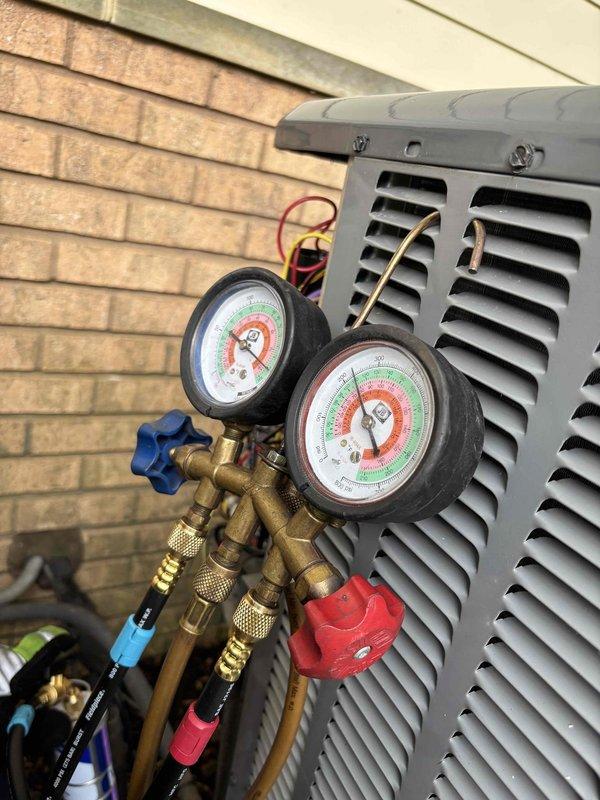 Performed AC renewal service on outdoor condensing unit. Connected manifold gauge set to measure system pressures and verify refrigerant charge levels. Completed comprehensive maintenance including system diagnostics and performance verification to ensure proper operation of the air conditioning system.