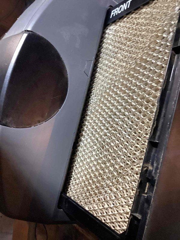 Performed routine HVAC cooling system maintenance inspection. Conducted temperature diagnostics of air handler unit, recording operating temperatures at 70.4°F. Inspected and evaluated evaporative cooling pad filter, which showed clean condition with proper mesh integrity and correct installation orientation in housing unit.