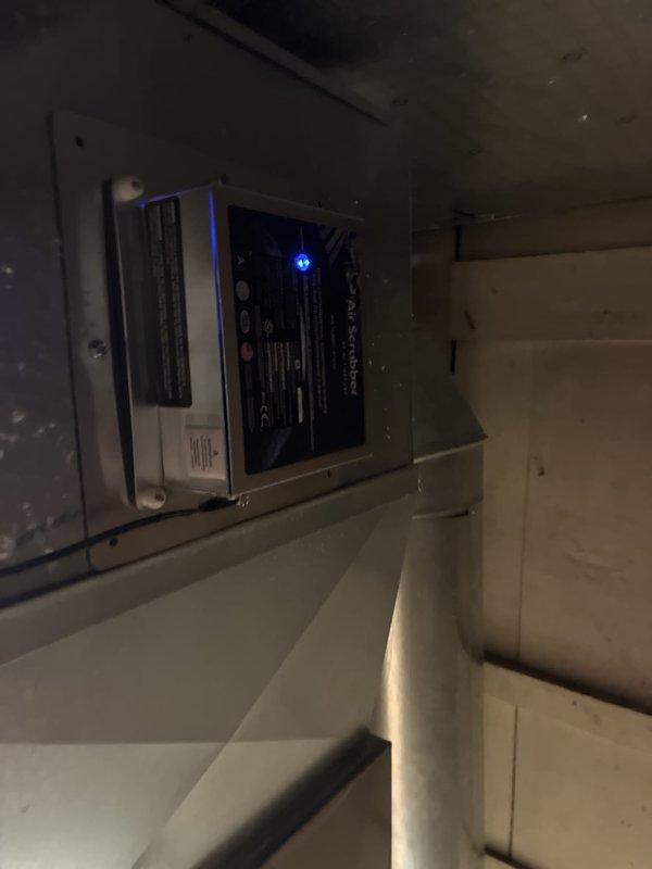 Completed commercial mini-split installation with integrated air scrubber system and dedicated electrical circuit. All components installed, wired, and tested with control system operational and displaying proper LED indicators, confirming system functionality.