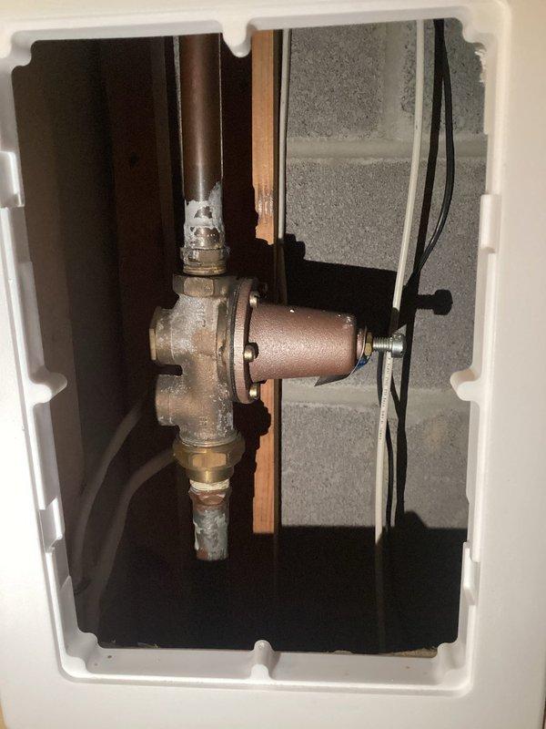 Performed routine maintenance flush on tanked water heater system. Drained sediment buildup from tank bottom through drain valve, refilled system, and verified proper water pressure at 60 PSI on gauge. Inspected copper supply lines and brass shutoff valve for leaks or corrosion—all connections secure with no active leaks detected.