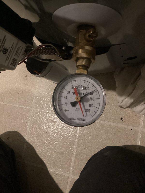 Performed routine maintenance flush on tanked water heater system. Drained sediment buildup from tank bottom through drain valve, refilled system, and verified proper water pressure at 60 PSI on gauge. Inspected copper supply lines and brass shutoff valve for leaks or corrosion—all connections secure with no active leaks detected.