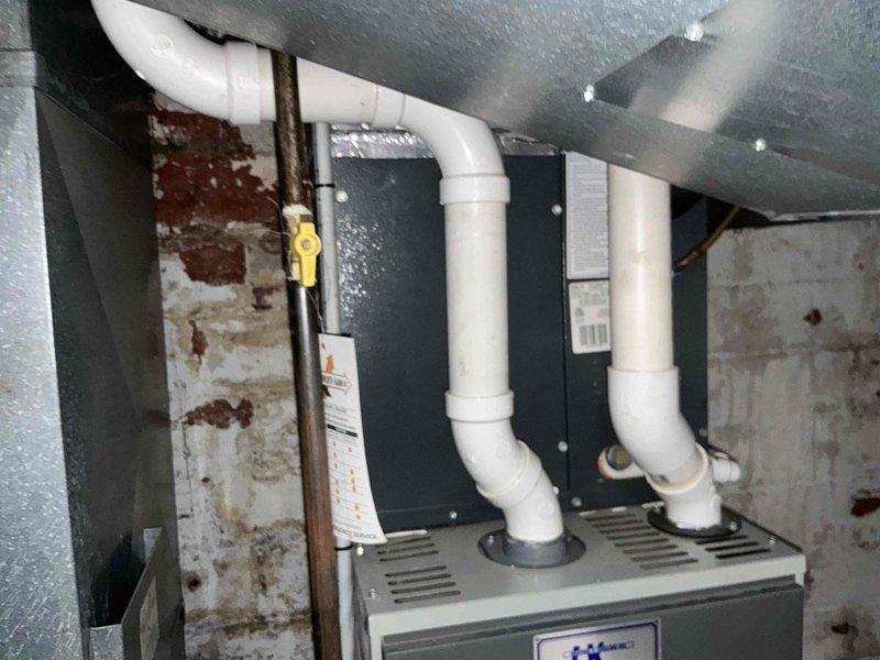 Provided comprehensive furnace replacement options for existing HVAC system in basement utility area. Evaluated current air handler configuration with PVC venting and documented equipment condition, surrounding infrastructure including copper refrigerant lines, and installation space parameters to develop appropriate replacement recommendations.
