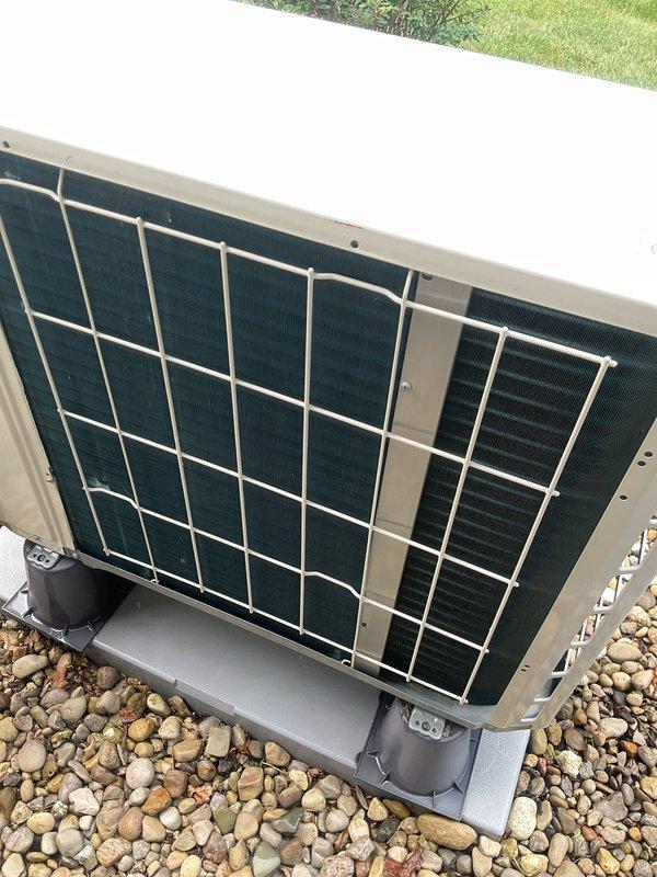 Performed routine HVAC cooling maintenance on residential air conditioning system. Inspected outdoor condenser unit with protective metal guard, confirmed proper mounting and drainage on gravel pad, and verified all components in good working condition. Measured supply air temperature at 55°F at indoor air handler located in attic space, confirming system operating within normal parameters.