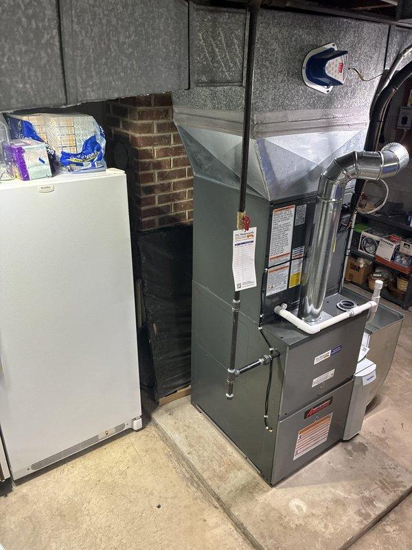 # HVAC Install - Complete System

Completed full residential HVAC system installation including 80% efficiency furnace, air conditioning condenser unit, humidifier, air scrubber, and chimney liner. Installed new furnace in basement mechanical room with proper venting through stainless steel exhaust piping connected to existing brick chimney structure. Mounted outdoor AC condenser unit on concrete pad against building exterior with appropriate clearances for airflow and service access. Ran refrigerant lines and electrical conduit from outdoor unit through foundation, connecting to indoor air handler. Installed whole-home humidification system and air scrubber for enhanced indoor air quality. Completed all ductwork connections to new equipment using metallic duct transitions at furnace plenum. Verified all electrical connections meet code requirements, with proper disconnect and meter coordination. Tested system startup, confirmed proper operation of heating and cooling cycles, verified 