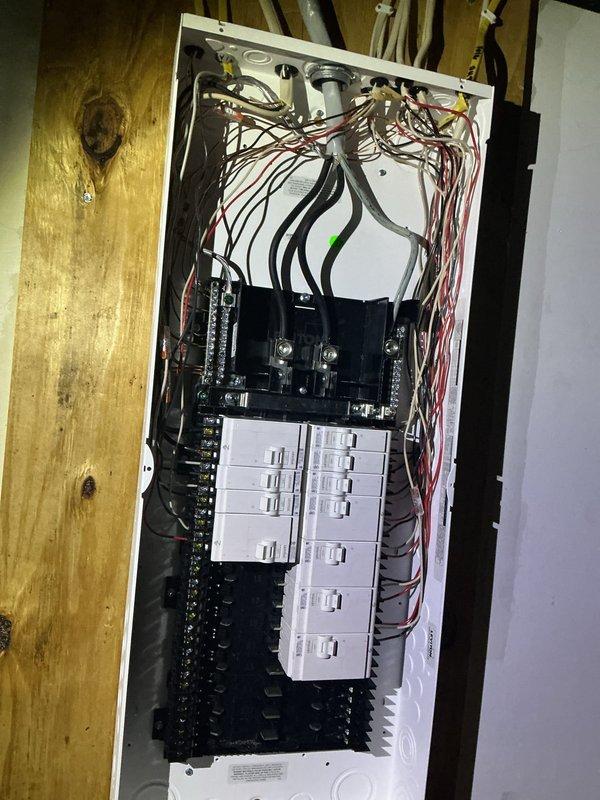 Completed full residential electrical panel upgrade, replacing existing load center with new panel assembly. Installed main breaker assembly with proper conductor terminations and organized two columns of circuit breakers for branch circuit distribution. Routed and terminated all branch circuit wiring with appropriate color-coding, updated circuit directory with clear labeling of all circuits, and verified proper panel installation on existing wall structure with all connections secure and code-compliant.