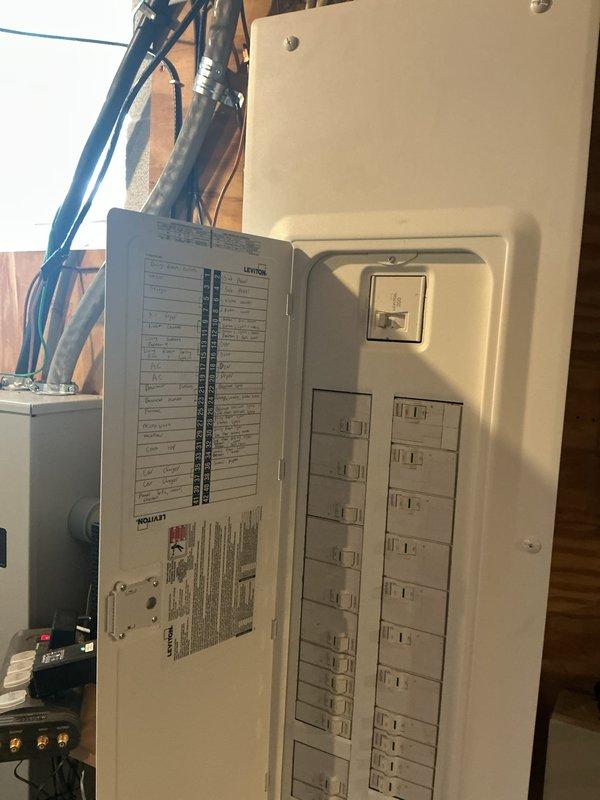 Completed full residential electrical panel upgrade, replacing existing load center with new panel assembly. Installed main breaker assembly with proper conductor terminations and organized two columns of circuit breakers for branch circuit distribution. Routed and terminated all branch circuit wiring with appropriate color-coding, updated circuit directory with clear labeling of all circuits, and verified proper panel installation on existing wall structure with all connections secure and code-compliant.
