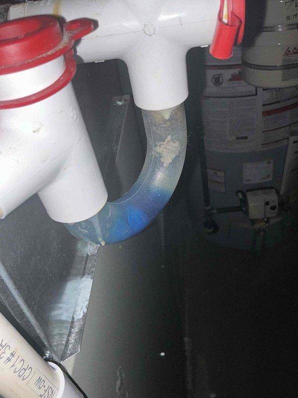 Completed HVAC system estimate for equipment replacement in residential utility space with easy access conditions. Evaluated existing furnace unit with associated ductwork, refrigerant lines, condensate drainage system including P-trap configuration, and electrical connections. Documented current system components including air handler plenum, flexible ductwork, copper refrigerant piping, and PVC condensate drain assembly to provide comprehensive replacement options for aging equipment showing signs of wear.