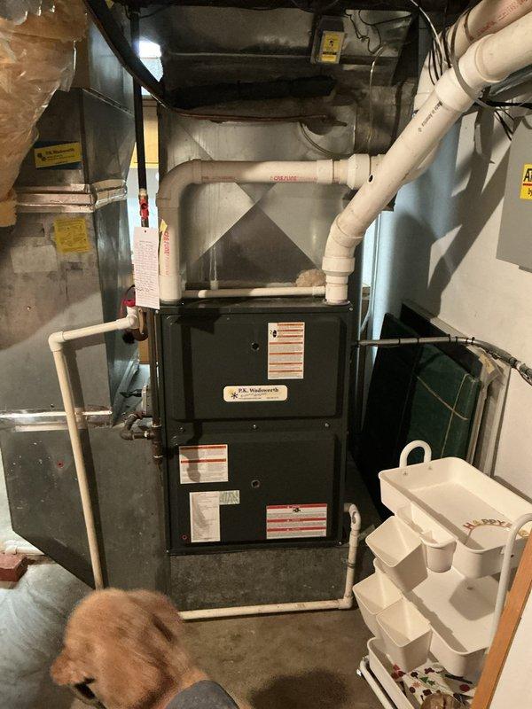 # HVAC Cooling System Maintenance Completed

Performed comprehensive seasonal cooling maintenance on residential HVAC system located in basement mechanical room. Conducted thorough inspection of furnace unit and associated cooling components, verifying all manufacturer specifications and safety labels were intact and legible.

Identified significant accumulation of dust, debris, and fibrous material throughout evaporator coil fins, which was restricting airflow and reducing system efficiency. Performed detailed cleaning of coil assembly, removing dirt buildup and lint from between metal fins to restore proper heat transfer capability and optimal airflow. Cleared all obstructions from fin spaces to ensure maximum cooling performance.

Inspected all PVC drainage piping and ventilation connections for proper routing and secure attachment points. Verified flexible ductwork connections at plenum were sealed and properly supported. Examined metal ductwork components for air leaks or separati