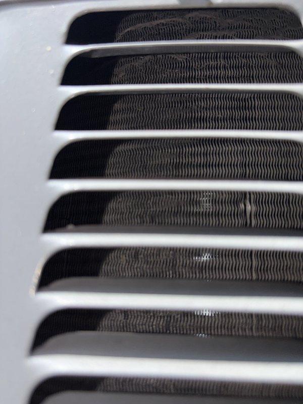 Completed scheduled preventive maintenance on residential cooling system. Performed comprehensive inspection of HVAC equipment including ductwork temperature verification in attic space, recording supply air temperature at 70.3°F, and confirmed proper airflow through return air grille with clean filter media and unobstructed louvers. All system components operating within normal parameters with no deficiencies noted.