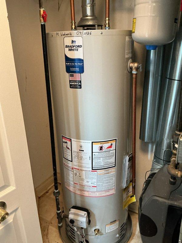 Completed return visit to install Bradford White 40-gallon residential water heater with required code upgrades. Installation included proper copper piping connections, expansion tank mounting, code-compliant venting with metal flue pipe, and integration with existing HVAC system in utility room. All connections pressure-tested and unit operational upon completion.