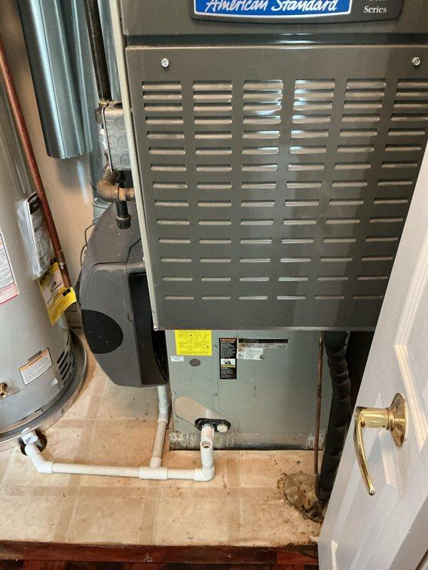 Completed return visit to install Bradford White 40-gallon residential water heater with required code upgrades. Installation included proper copper piping connections, expansion tank mounting, code-compliant venting with metal flue pipe, and integration with existing HVAC system in utility room. All connections pressure-tested and unit operational upon completion.