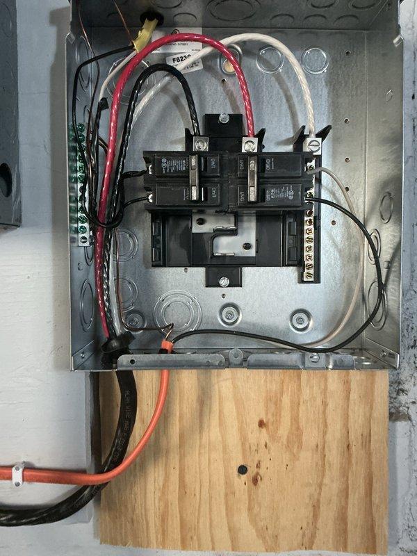 Installed new Siemens sub panel and circuit breaker system with 15 amp maximum capacity rated at 11.1 minimum amps. Completed full electrical panel installation including proper circuit breaker arrangement, wire routing, and ground bar connections with appropriate color-coded wiring throughout the enclosure. All circuits were properly labeled for identification, including A/C condenser and other designated loads, and the panel was mounted on plywood backing with all connections secured to code specifications.