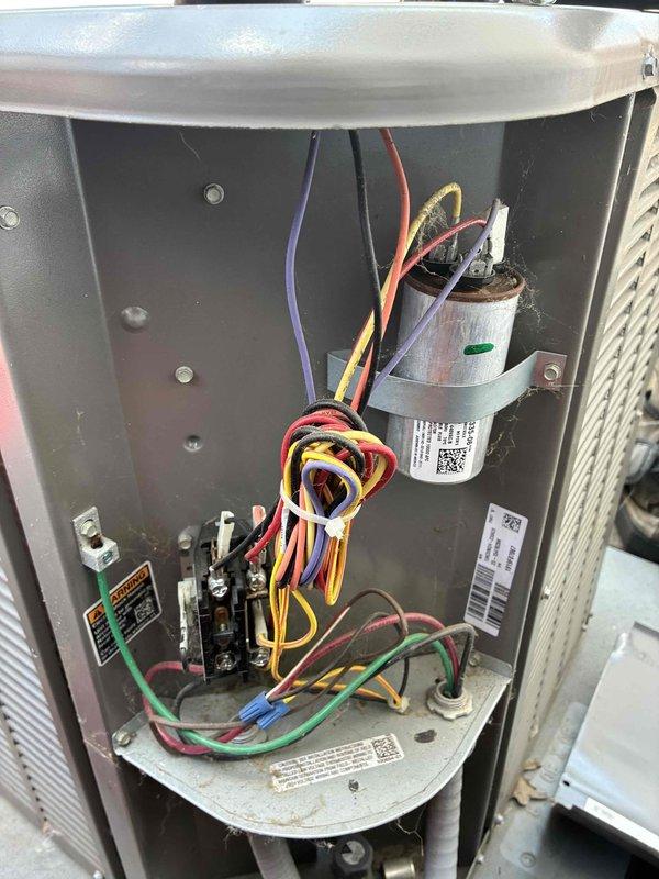 Performed cooling system tune-up on residential HVAC unit. Removed access panel to inspect electrical components, capacitor, contactor, and control board for proper operation. Connected manifold gauges to measure refrigerant pressures and verify system performance within manufacturer specifications.