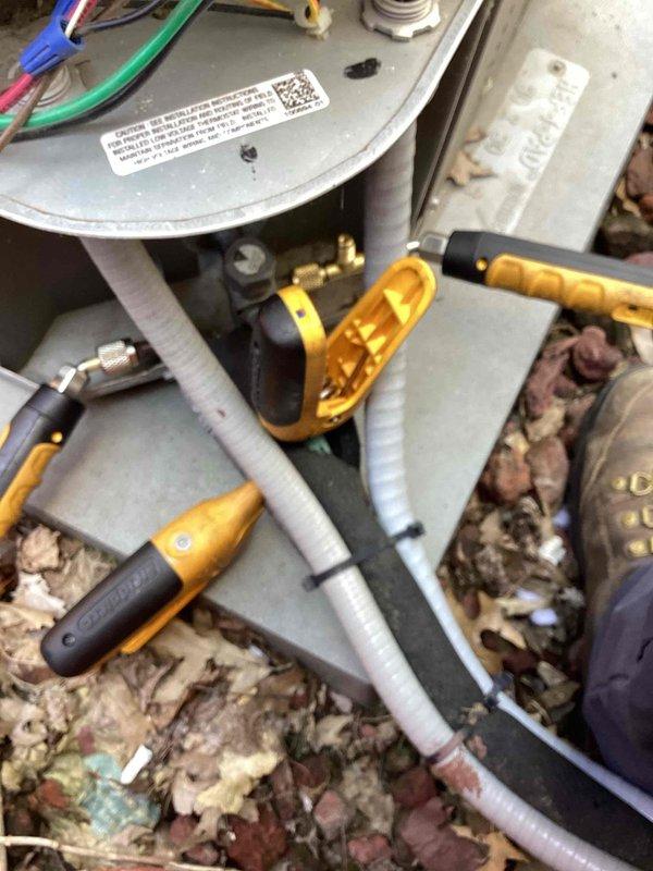 Performed cooling system tune-up on residential HVAC unit. Removed access panel to inspect electrical components, capacitor, contactor, and control board for proper operation. Connected manifold gauges to measure refrigerant pressures and verify system performance within manufacturer specifications.