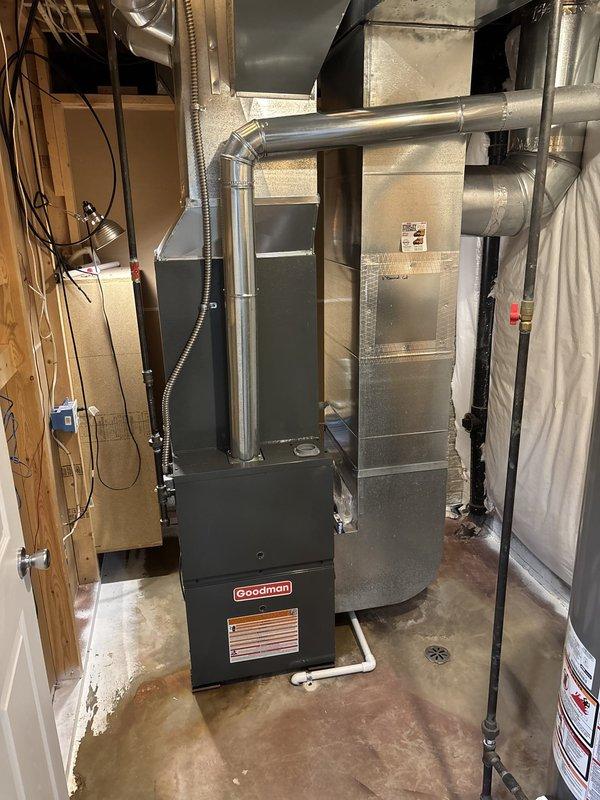 Completed full HVAC system installation in basement utility area, including new Goodman 80% efficiency furnace and air conditioning system. Installed furnace unit on concrete pad with proper clearances, connected metallic supply and return ductwork with professional-grade fittings and elbow transitions, and integrated flexible ducting where required. Routed all electrical connections to code, established proper condensate drainage system, and verified system operation and airflow throughout the home.