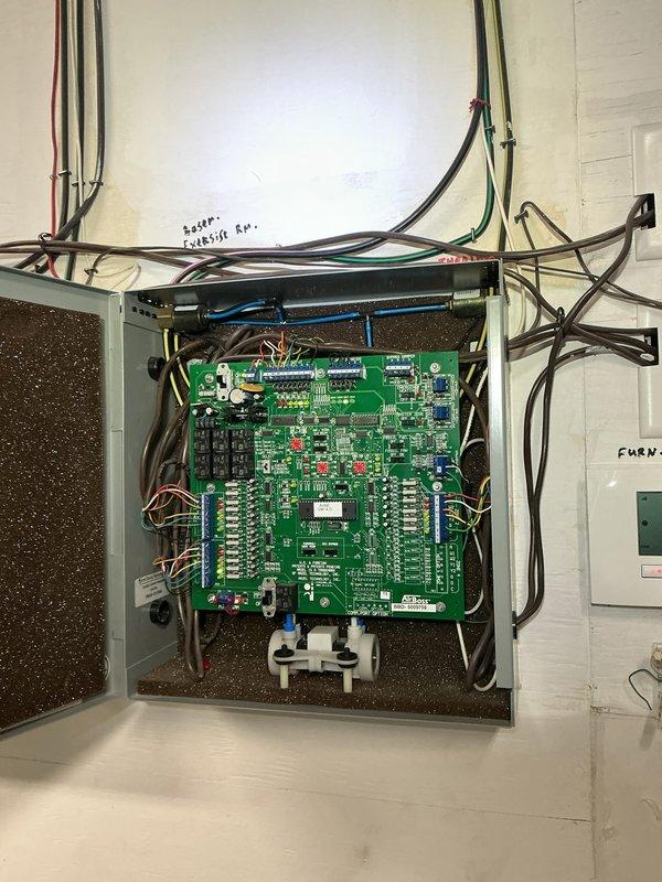 Responded to no cooling complaint caused by pet damage to low-voltage control wiring at outdoor condensing unit. Inspected electrical control panel and circuit board, documented extensive wire damage to thermostat and control circuits, and assessed system operability. Recommended complete rewiring of damaged conductors and verification of control board functionality to restore proper system operation.