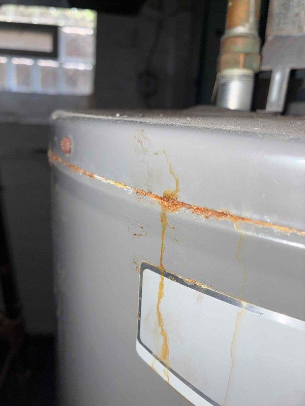 Completed cooling system tune-up and inspection. Upon arrival, observed significant rust and corrosion on water heater connections and HVAC cabinet panels, indicating potential moisture intrusion issues. Documented existing corrosion on metal fittings and cabinet surfaces for customer awareness and future monitoring.