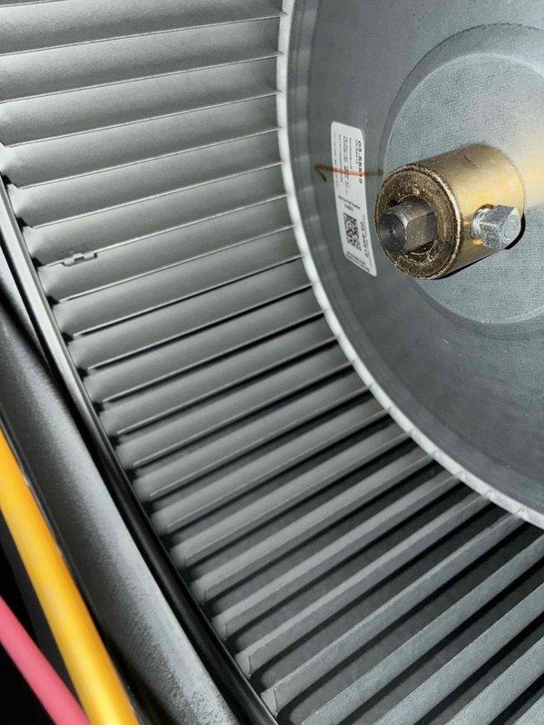 Performed routine HVAC cooling maintenance on residential air handler system. Inspected blower wheel assembly and motor components, confirming proper mechanical condition and secure mounting hardware. Documented return air grille with accumulated dust buildup on slats, indicating normal system operation and standard filter maintenance needs.