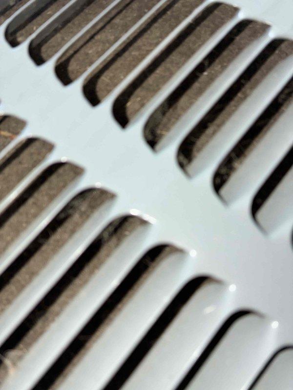 Performed routine HVAC cooling maintenance on residential air handler system. Inspected blower wheel assembly and motor components, confirming proper mechanical condition and secure mounting hardware. Documented return air grille with accumulated dust buildup on slats, indicating normal system operation and standard filter maintenance needs.