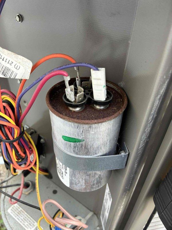 Performed routine preventive maintenance on residential cooling system. Inspected outdoor condenser unit, confirming coils are clean with no debris accumulation and fins are straight and undamaged. Verified capacitor connections are secure with proper wire terminations, and all electrical components within unit are functioning properly with no signs of wear or deterioration.