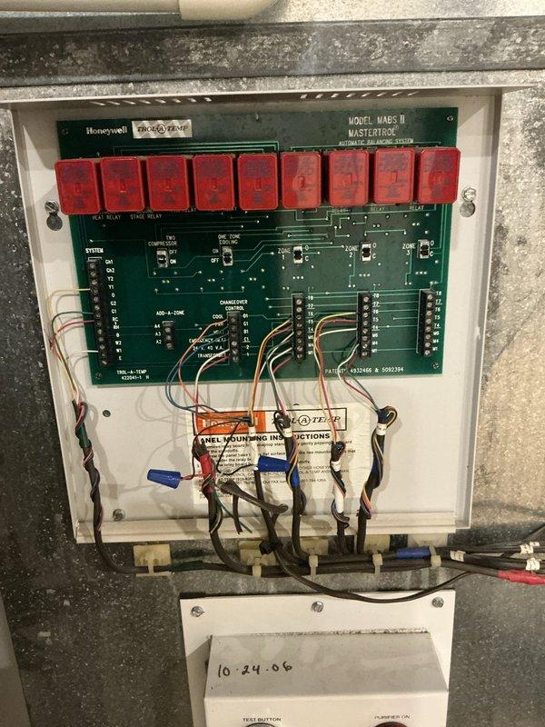 Responded to service call for non-functional zoning system following recent HVAC installation. Inspected and documented existing Honeywell Model Mark II Mastertrol zoning control panel with nine relay switches and associated wall-mounted zone thermostat. Evaluated outdated zoning system components, wiring connections, and control board functionality to assess compatibility issues with newly installed equipment and provide estimate for ductwork and zoning system upgrades.