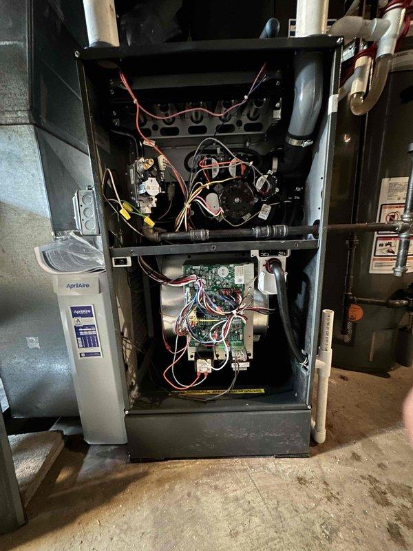 # HVAC Cooling Maintenance Completed

Performed comprehensive seasonal cooling maintenance on residential HVAC system. Conducted thorough inspection of furnace and air handler components with front access panel removed for complete system evaluation. Verified proper operation of gas valve assembly, checked all electrical connections at terminal blocks, and inspected control board wiring integrity. Examined blower motor assembly, capacitor, and associated electrical components for wear and proper function. All wire connections at brass terminals were inspected and found secure with no signs of overheating or degradation. System components photographed and documented showing normal operating condition with no immediate service needs identified.