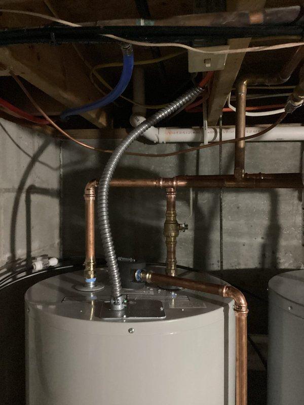 Replaced existing water heater with new 50-gallon tall Bradford White electric water heating unit including installation of drain pan for secondary protection. Connected copper supply lines, flexible conduits, and all electrical connections per manufacturer specifications and local code requirements.