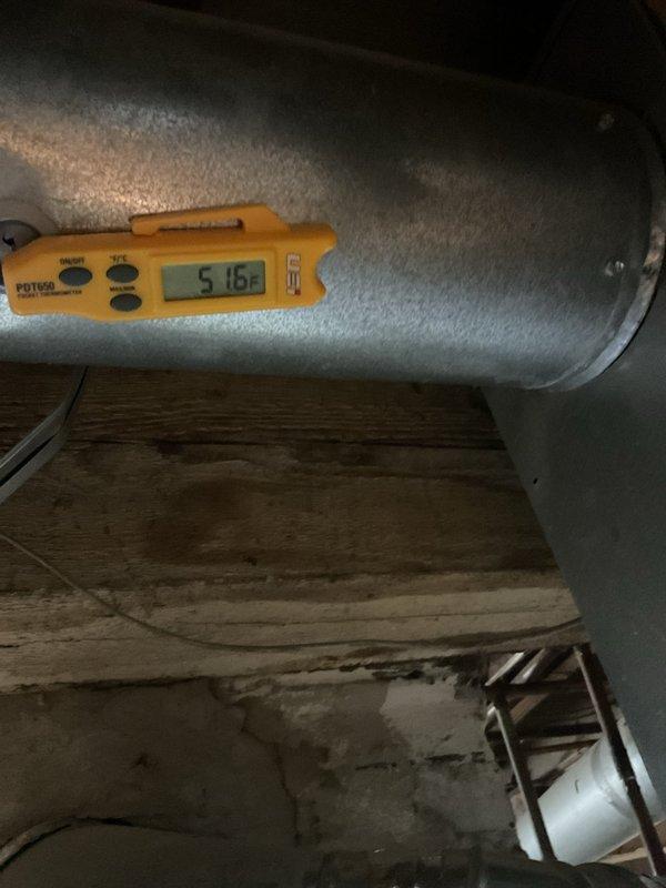 Completed contract cooling tune-up on residential Airtemp furnace system. During inspection, discovered severe frost accumulation on supply ductwork in attic space, with surface temperature measuring 51.6°F, indicating significant airflow restriction or refrigerant issue affecting cooling performance. Documented equipment condition and duct frost buildup for further diagnostic evaluation and necessary repairs to restore proper system operation.